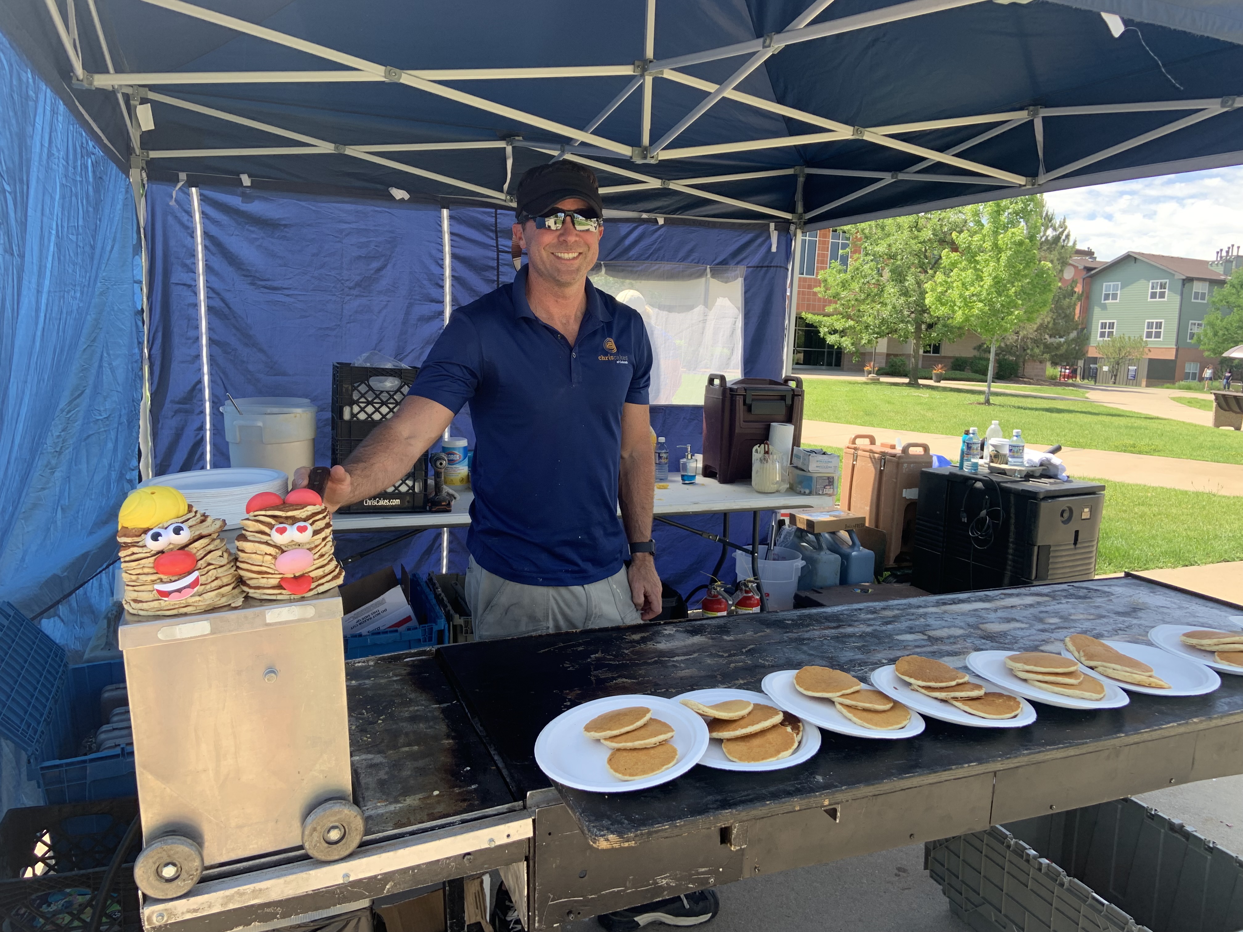 Owner serving fresh pancakes at a Colorado event